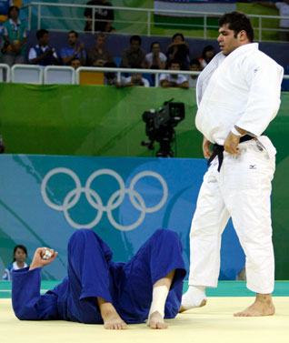 Daniel McCormick of the U.S. lies next to Mohammad Reza Rodaki of Iran during their men's +100kg repechage judo match at the Beijing 2008 Olympic Games August 15, 2008. REUTERS/Kim Kyung-Hoon (CHINA)